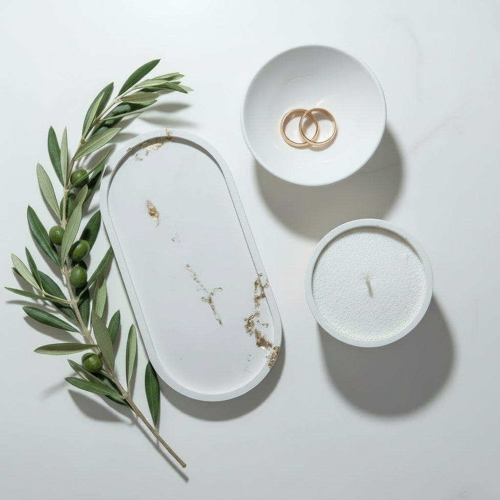 Three white ceramic items on a white surface