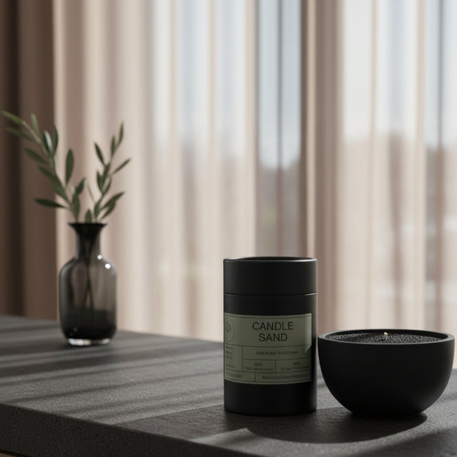 Candle sand container and a black candle on a concrete surface 