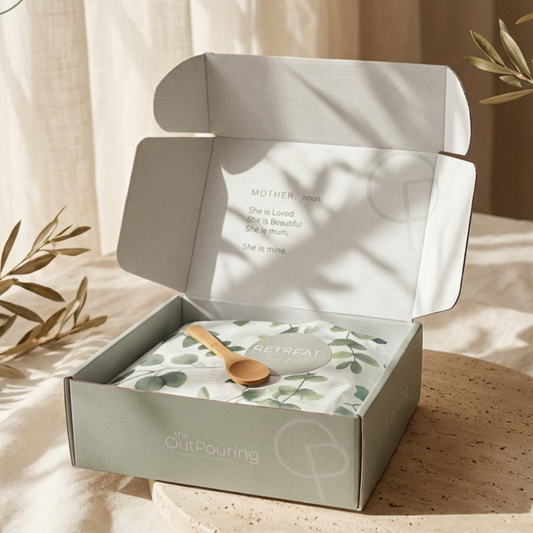 Open box with a product on a wooden surface with natural light and plants.