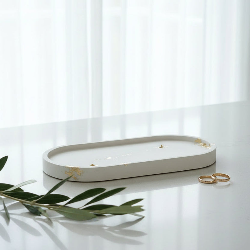 White decorative tray with gold accents on a bench